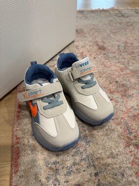 Kids White and Blue Athletic Sneakers with Orange Accent